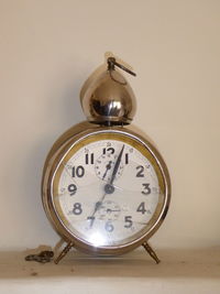 Close-up of clock on table