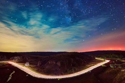 Scenic view of land against sky at night