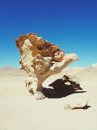 Rock formation on land against clear sky