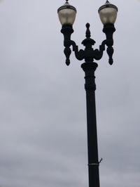 Low angle view of street light against sky