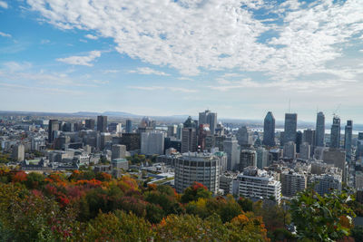 View of cityscape against cloudy sky