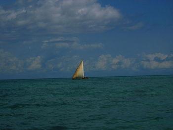 Sailboat sailing in sea against sky