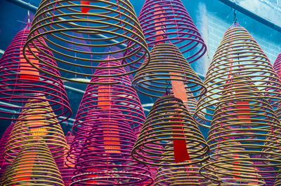 Low angle view of multi colored umbrellas hanging in temple