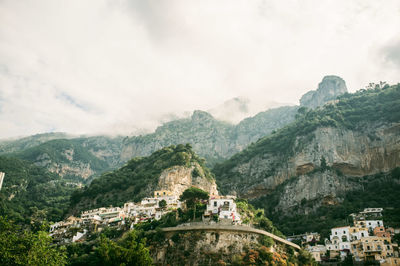 Low angle view of buildings on mountains at positano