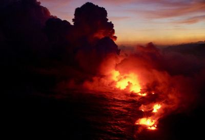 Scenic view of lava against sunset