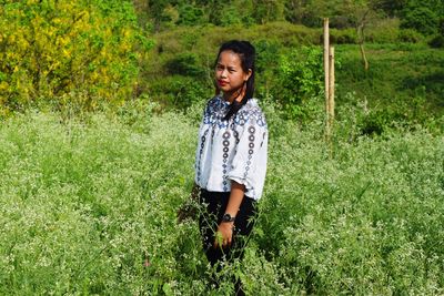 Portrait of woman standing on field