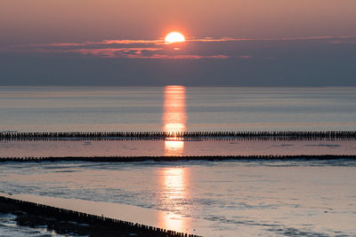 Scenic view of sea against orange sky