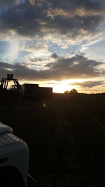 Scenic view of field against sky during sunset