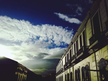 Low angle view of building against cloudy sky