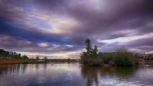 Scenic view of lake against cloudy sky