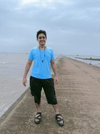 Portrait of man on beach against sky