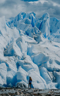 Woman standing against the prep perito moreno glacier