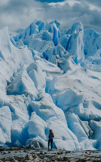 Full length of person on snowcapped mountains against sky