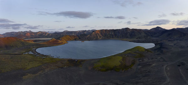 Calm lake surrounded by mountains