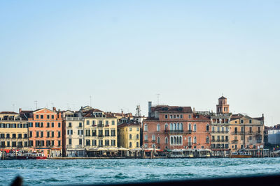 Buildings in city against clear sky