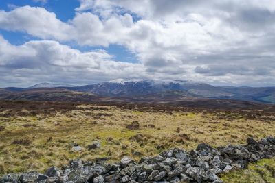 Scenic view of mountains against cloudy sky