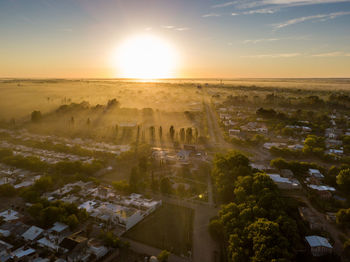 Aerial view of cityscape against sky during sunset