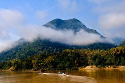 Scenic view of lake and mountains against sky