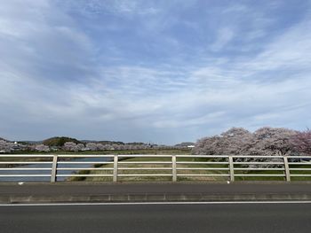 Road by bridge against sky