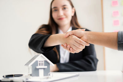 Cropped hand of woman using mobile phone