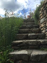 Stone wall against cloudy sky