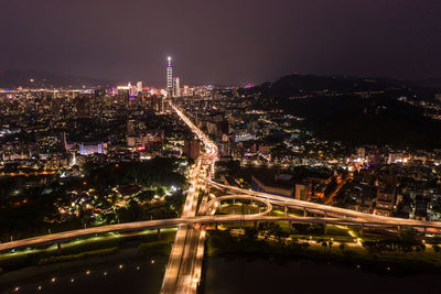 High angle view of illuminated city buildings at night