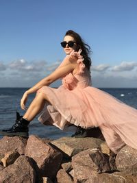 Portrait of woman standing at beach