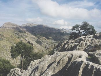 Rock formations at sierra de tramuntana against cloudy sky 