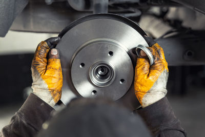 Close-up of man working on machine