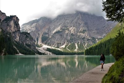 Scenic view of lake by mountains against sky