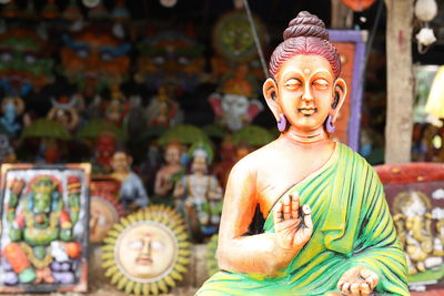 Statue of buddha for sale at market stall