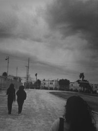 Silhouette of woman against cloudy sky