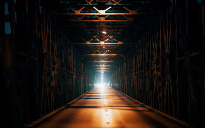 Car approaching on illuminated bridge