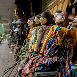 Wooden puppets for sale at market stall