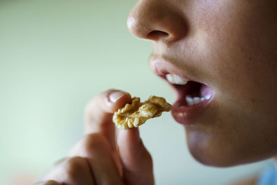 Close-up of young woman eating food