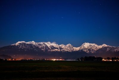 Scenic view of field against clear sky at night