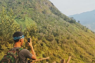 Man photographing on mountain