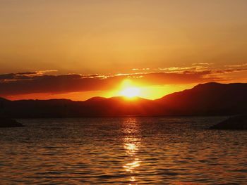 Scenic view of sea against romantic sky at sunset