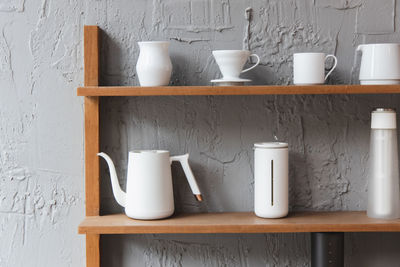 Close-up of coffee cup on table against wall