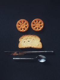 High angle shot of slice of bread cookies knife and spoon 