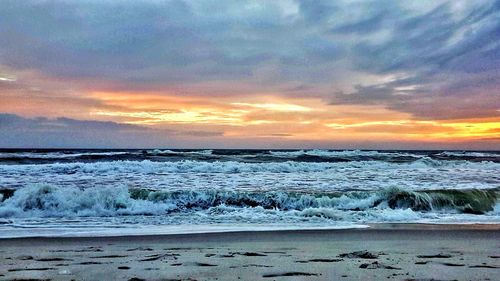 View of sea against cloudy sky during sunset