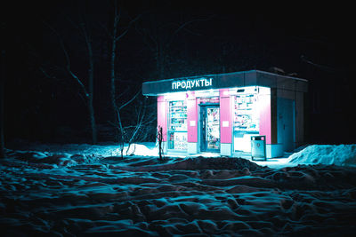 Text on snow covered land at night