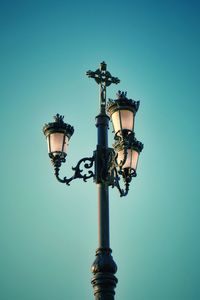 Low angle view of street light against blue sky