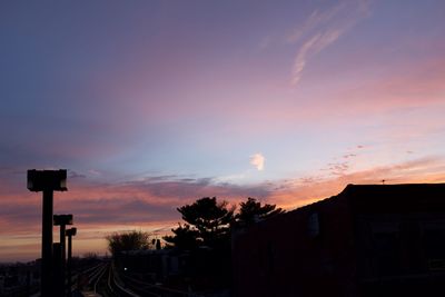 Silhouette buildings against sky at sunset