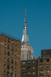 Low angle view of buildings against blue sky