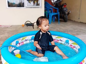 Cute boy playing in swimming pool