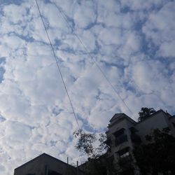 Low angle view of building against cloudy sky