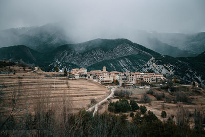 Aerial view of buildings against mountain range