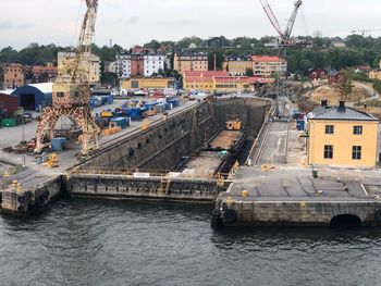 Sailboats in river against sky in city