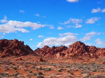 Scenic view of mountains against blue sky